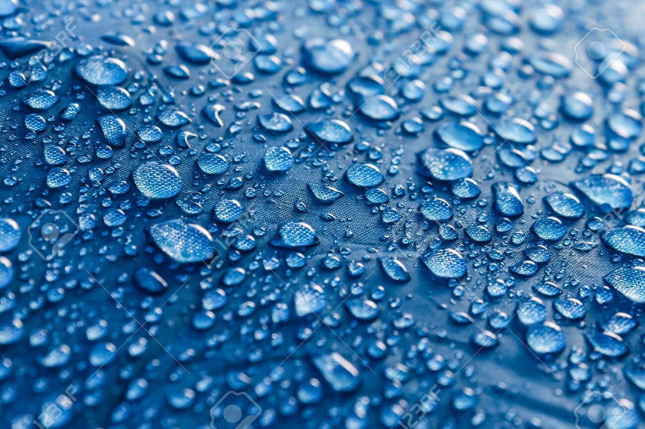 Water drops on the fabric. Rain Water droplets on blue fiber wat