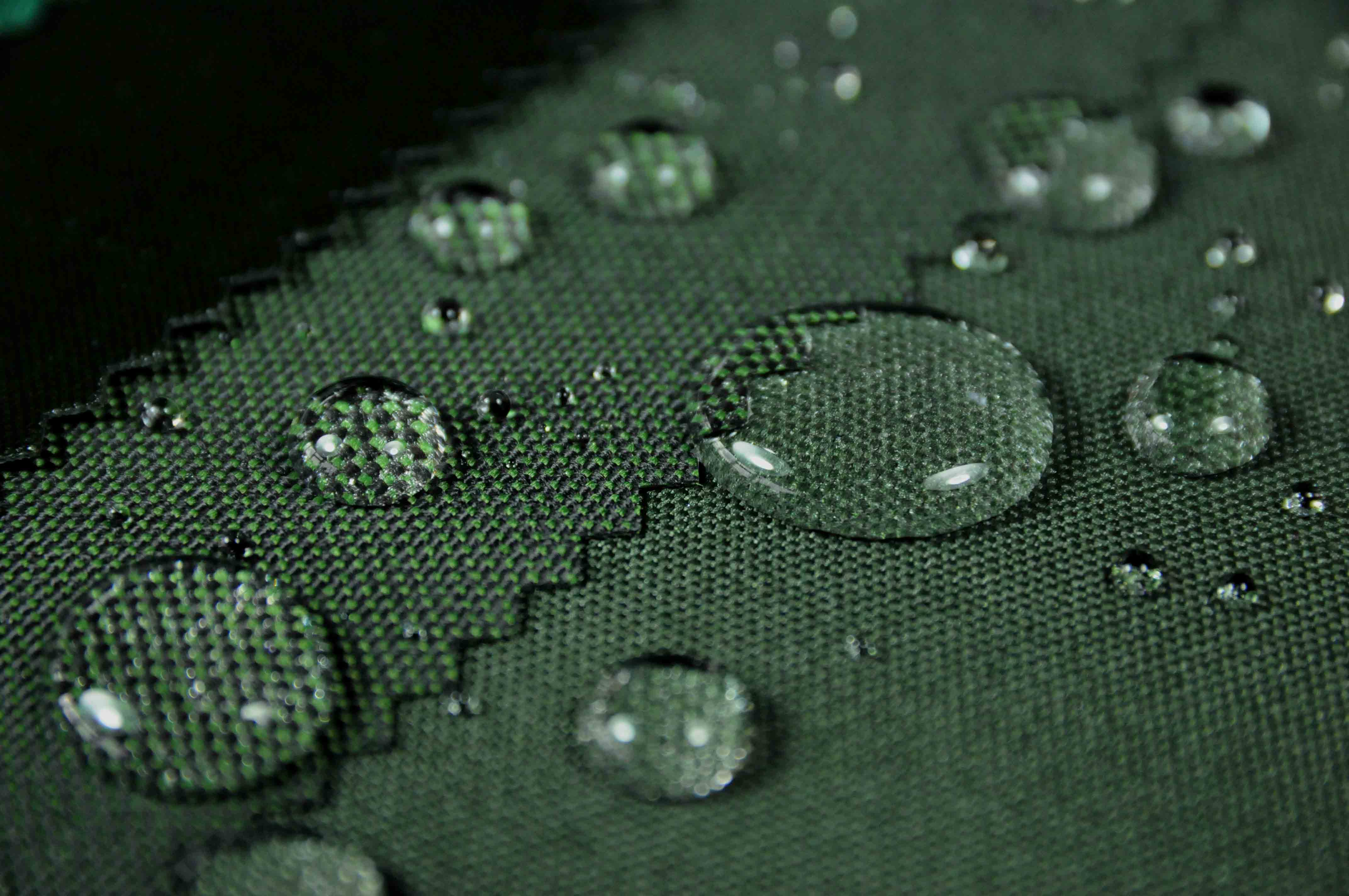green-fleck-waterproof-polyester-outdoor-fabric-testing-water-droplets